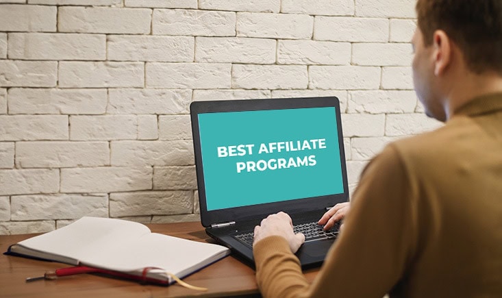 Image of a person looking at a laptop with text "best affiliate programs"